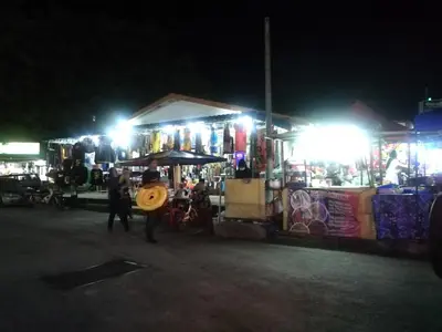 a person holding a frisbee at a market at night at Pangkor Coral Bay Homestay 315 in Pangkor