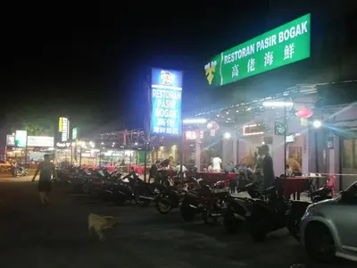 a group of motorcycles parked on a street at night at Pangkor Coral Bay Homestay 315 in Pangkor