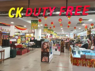 a cvs drugstore with a ck duty free sign in the aisle at Pangkor Coral Bay Resort(2 bedrooms) in Pangkor
