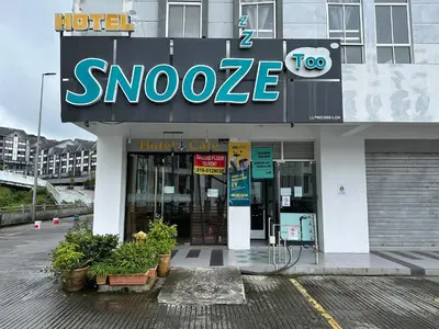 a store with a large sign on the front of it at Snooze TOO in Brinchang