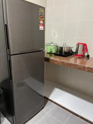 a refrigerator in a kitchen with some pots and pans at Cameron Emerald Avenue @ Brinchang in Cameron Highlands