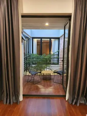 a room with a balcony with a table and chairs at Luxurious 7 BR Heritage House in UNESCO Historic Geogetown in George Town
