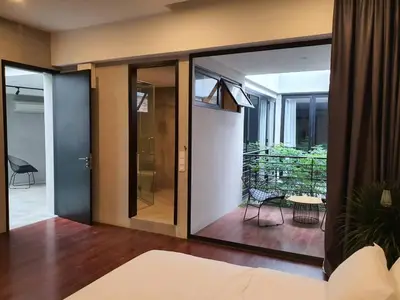 a room with sliding glass doors and a balcony at Luxurious 7 BR Heritage House in UNESCO Historic Geogetown in George Town