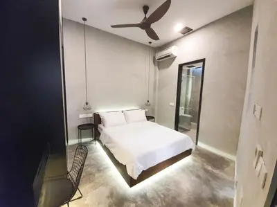 a bedroom with a white bed and a ceiling fan at Luxurious 7 BR Heritage House in UNESCO Historic Geogetown in George Town