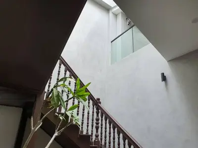 a stairway with a plant in front of a building at Luxurious 7 BR Heritage House in UNESCO Historic Geogetown in George Town