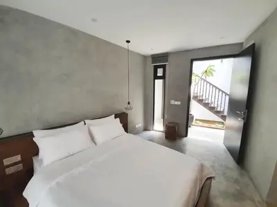 a bedroom with a white bed and a large window at Luxurious 7 BR Heritage House in UNESCO Historic Geogetown in George Town