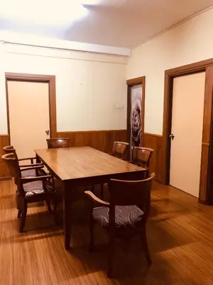 a dining room with a wooden table and chairs at Crown Imperial Court Apt at Brinchang Centre in Brinchang