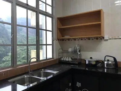 a kitchen with a sink and a counter top with windows at Crown Imperial Court Apt at Brinchang Centre in Brinchang