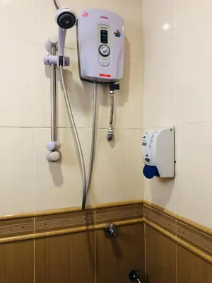 a bathroom with a hair dryer on the wall at Crown Imperial Court Apt at Brinchang Centre in Brinchang