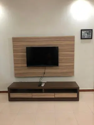 a living room with a flat screen tv on a wall at Crown Imperial Court Apt at Brinchang Centre in Brinchang