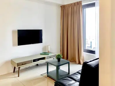 a living room with a tv and a couch at Georgetown Tropicana 218 Apartment in George Town
