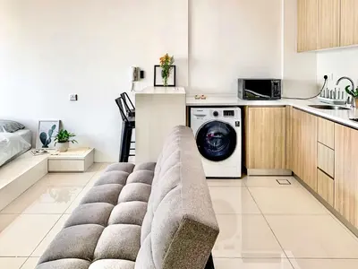 a living room with a couch and a washing machine at Georgetown Tropicana 218 Apartment in George Town