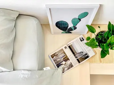 a picture of a cactus next to a bed at Georgetown Tropicana 218 Apartment in George Town