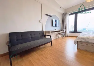a living room with a couch and a bed in it at Georgetown Tropicana 218 Apartment in George Town