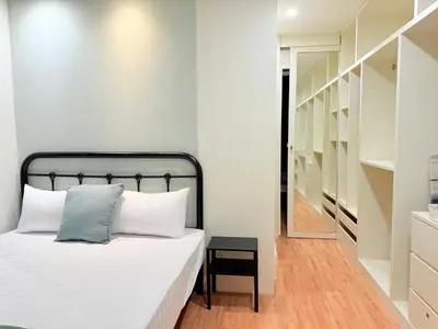 a bedroom with a bed with a black headboard at Ocean 19 Shamrock Villa Beachfront Big Group 4 Bedroom 5 Bathroom with Pool in Tanjung Bungah