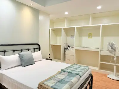 a bedroom with a bed and shelves and a fan at Ocean 19 Shamrock Villa Beachfront Big Group 4 Bedroom 5 Bathroom with Pool in Tanjung Bungah