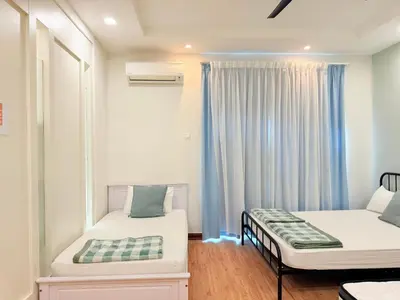 a small room with two beds and a window at Ocean 19 Shamrock Villa Beachfront Big Group 4 Bedroom 5 Bathroom with Pool in Tanjung Bungah