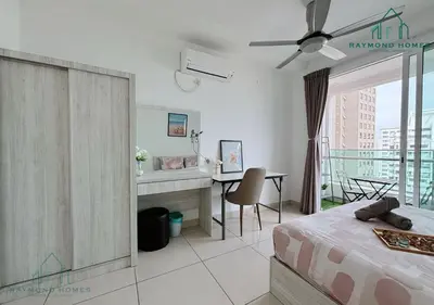 a bedroom with a bed and a desk and a balcony at Gurney Drive Mansion One Serviced Apartment in George Town