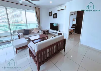 a living room with a couch and a tv at Gurney Drive Mansion One Serviced Apartment in George Town