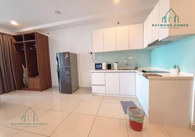 a kitchen with white cabinets and a stainless steel refrigerator at Gurney Drive Mansion One Serviced Apartment in George Town