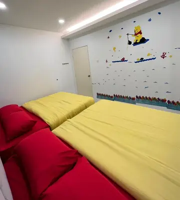 a bedroom with two beds and a wall with a lego mural at FuYoke Emerald Avenue @ Brinchang in Cameron Highlands