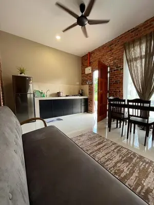 a kitchen and a living room with a ceiling fan at Cinta Abadi Resort in Bidur