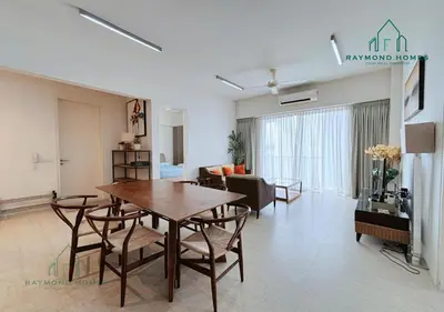 a living room with a table and chairs and a couch at Beachfront Resort By The Sea, Batu Ferringhi in Batu Ferringhi