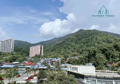 a view of a mountain with buildings and trees at Beachfront Resort By The Sea, Batu Ferringhi in Batu Ferringhi