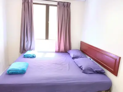 a bed in a room with a window at Pangkor Coral Bay Resort(3 bedrooms) \u4f11\u606f\u5c0f\u7ad9 in Pangkor