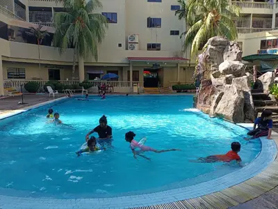 a group of children swimming in a swimming pool at Pangkor Coral Bay Resort(3 bedrooms) \u4f11\u606f\u5c0f\u7ad9 in Pangkor