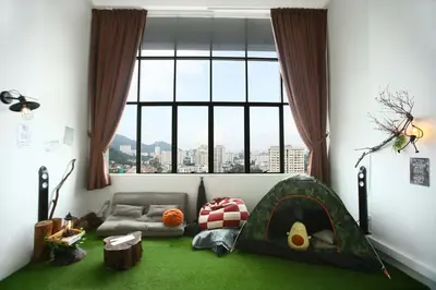 a room with a tent and a large window at Private Forest Camp - Cinema, Hammock, Swing at CEO Penang in Bayan Lepas