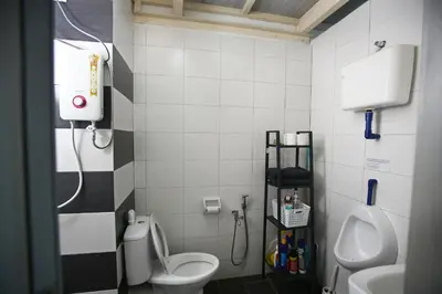 a bathroom with a toilet and a sink at Private Forest Camp - Cinema, Hammock, Swing at CEO Penang in Bayan Lepas