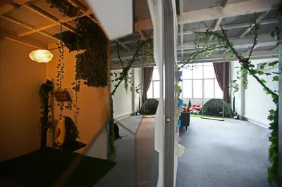 a hallway with plants on the walls of a building at Private Forest Camp - Cinema, Hammock, Swing at CEO Penang in Bayan Lepas