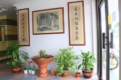 a room with plants and pictures on the wall at Hotel Lam Seng in Pantai Remis