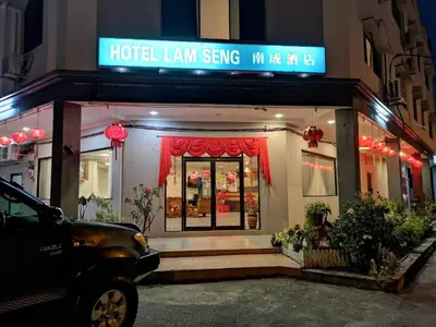 a hotel lean serving sign in front of a building at Hotel Lam Seng in Pantai Remis