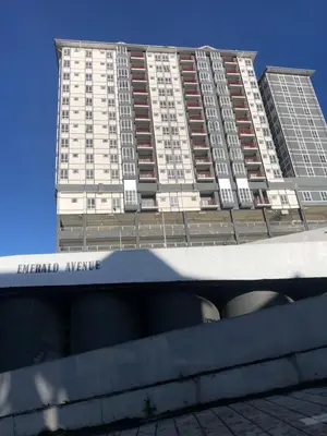 a tall apartment building in front of a building at Ramadhina Eagle Eye View Home2stay Emerald Avenue in Brinchang