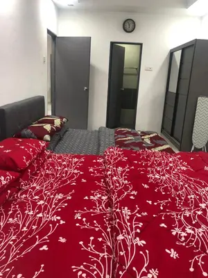 a bedroom with a red comforter on a bed at Ramadhina Eagle Eye View Home2stay Emerald Avenue in Brinchang