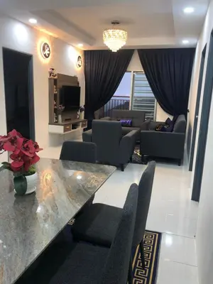 a living room with a couch and a table and chairs at Ramadhina Eagle Eye View Home2stay Emerald Avenue in Brinchang