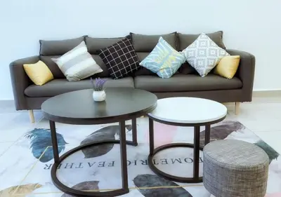 a living room with a couch and two tables at \u805a\u4e50\u5c4b\u6c11\u5bbfJyuraku homestay The venus sitiawan in Sitiawan