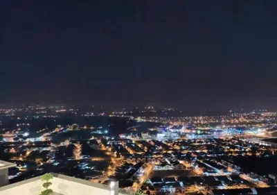 a view of a city lit up at night at \u805a\u4e50\u5c4b\u6c11\u5bbfJyuraku homestay The venus sitiawan in Sitiawan
