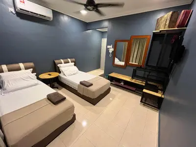 a hotel room with two beds and a mirror at EagleNest at Marina Cove Resort in Lumut