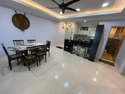 a dining room and kitchen with a table and chairs at EagleNest at Marina Cove Resort in Lumut