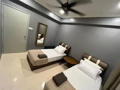a bedroom with two beds and a ceiling fan at EagleNest at Marina Cove Resort in Lumut