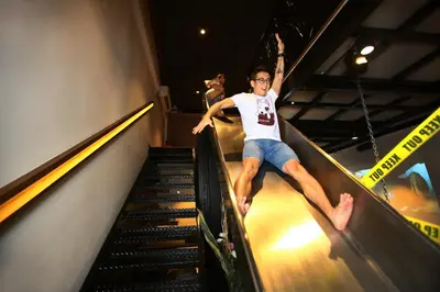 a man riding down an escalator at Private Getaway (Private Cinema, Swing & more!) at CEO Penang in Bayan Lepas