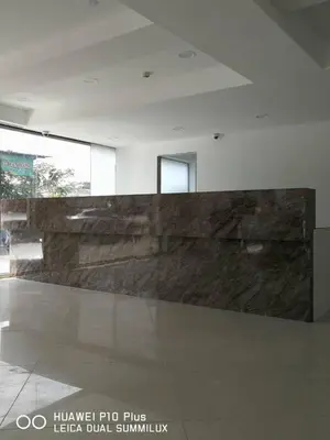 a lobby with a large stone wall in a building at Grand Bagan Hotel in Butterworth