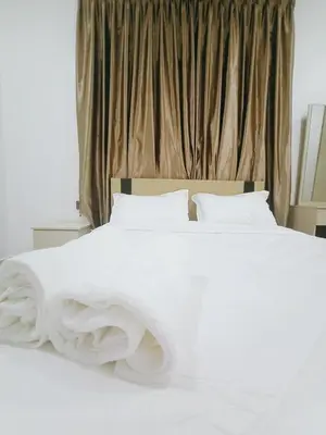 a white bed with white sheets and pillows at Cozy Corner House #4 Bedroom #3 Bathroom in Ipoh