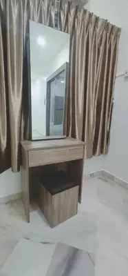 a mirror on a wooden table in front of a window at Cozy Corner House #4 Bedroom #3 Bathroom in Ipoh