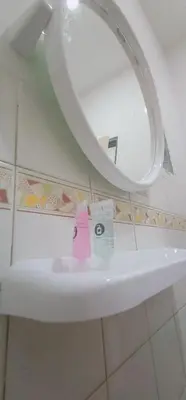 a bathroom with a sink with a pink toothbrush and a mirror at Cozy Corner House #4 Bedroom #3 Bathroom in Ipoh