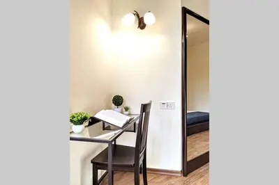 a desk with a chair and a mirror at EEs Whale House - Homestay 3 min walk to beach in Batu Ferringhi