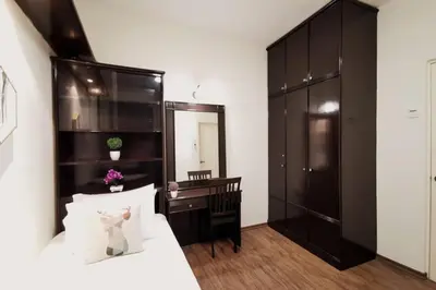 a bedroom with a bed and a desk and a mirror at EEs Whale House - Homestay 3 min walk to beach in Batu Ferringhi